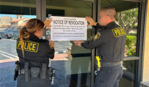two agents post notice of revocation on the glass door
